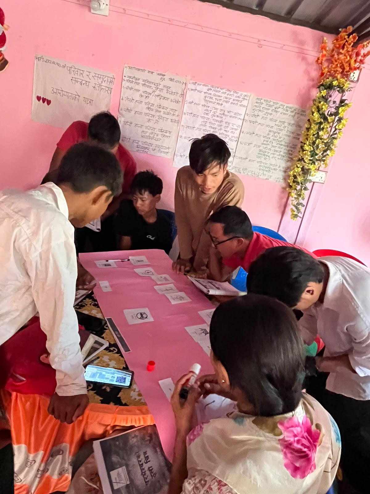 Nepali disciples gathered around a table in a small-group Bible learning activity